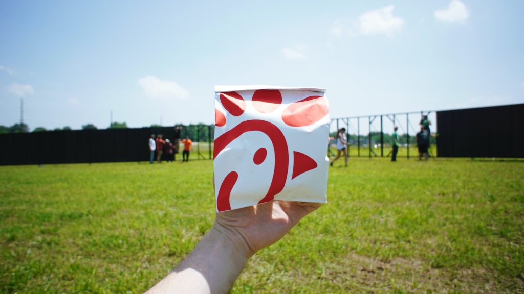 military personnel holding white and red box