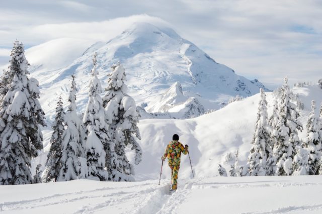 military service member in yellow jacket and black pants standing on snow covered ground