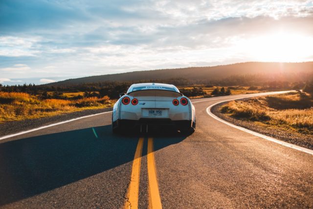 silver sports coupe from Alamo on asphalt road