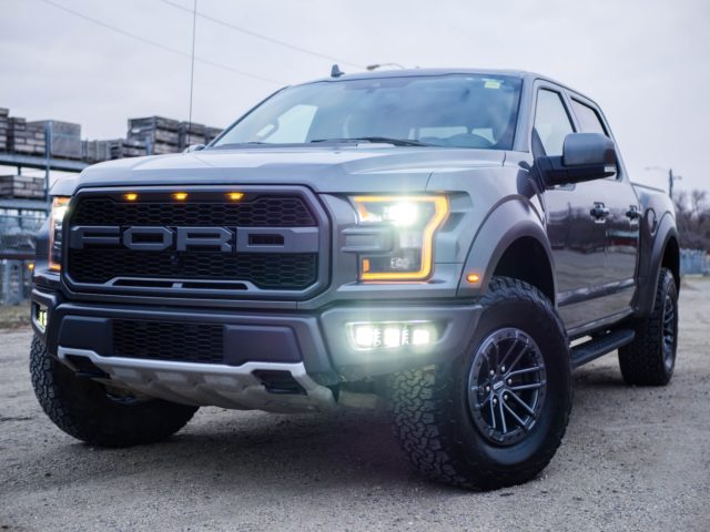 black ford crew cab pickup truck on road during daytime