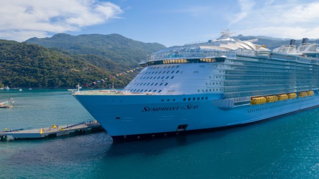 white royal caribbean cruise ship docked beside port