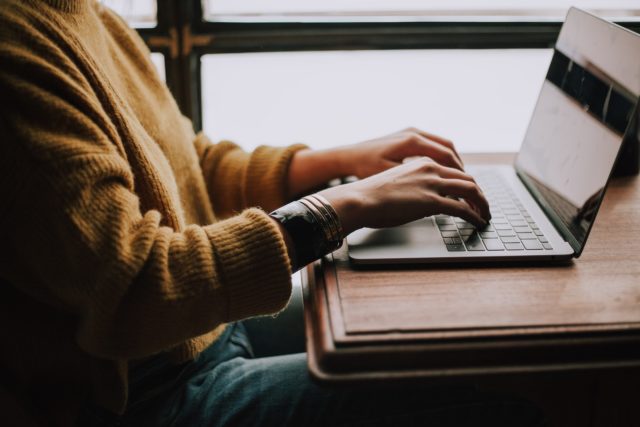 person sitting front of laptop doing test prep