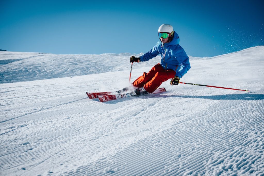 military man ice skiing on hill