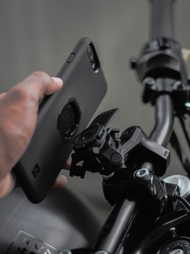 a military officer holding a cell phone near a bike