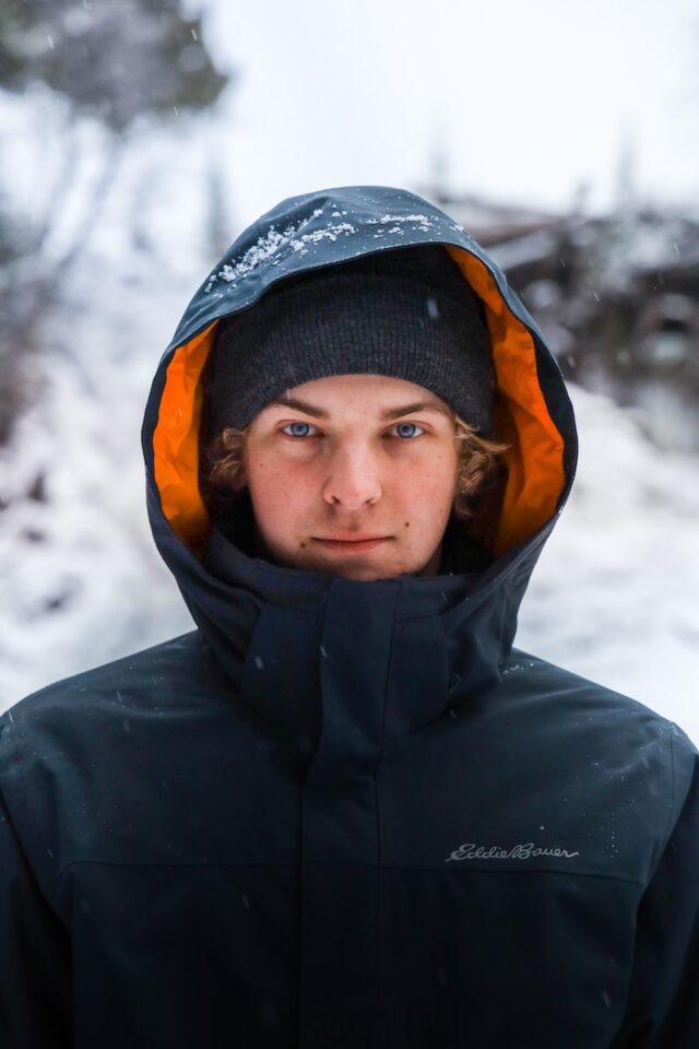 a young man in a black eddie bauer jacket