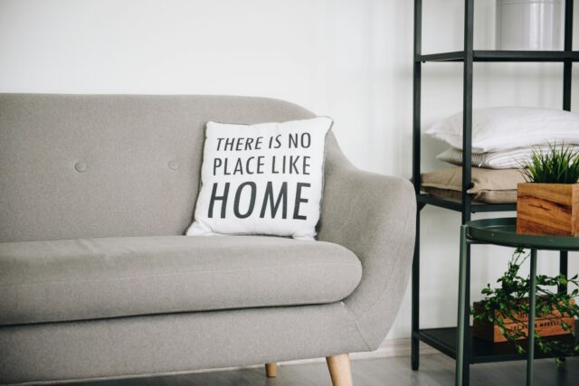 white throw pillow on gray sofa from at home