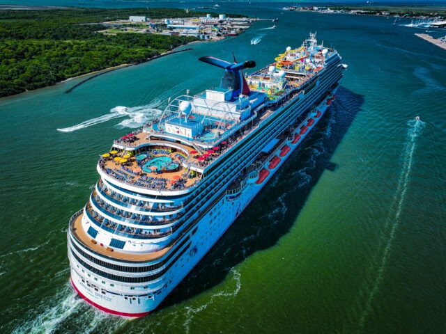 a large carnival cruise ship in the middle of a body of water