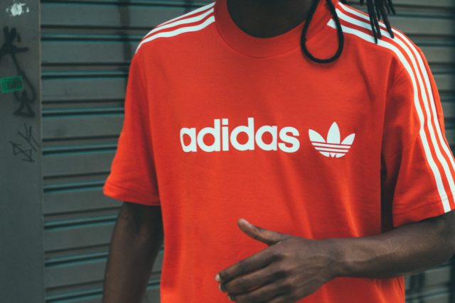 military man wearing red and white adidas crew-neck T-shirt