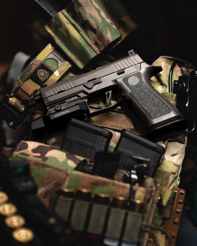 a close up of a shadow systems firearm on a camouflage bag